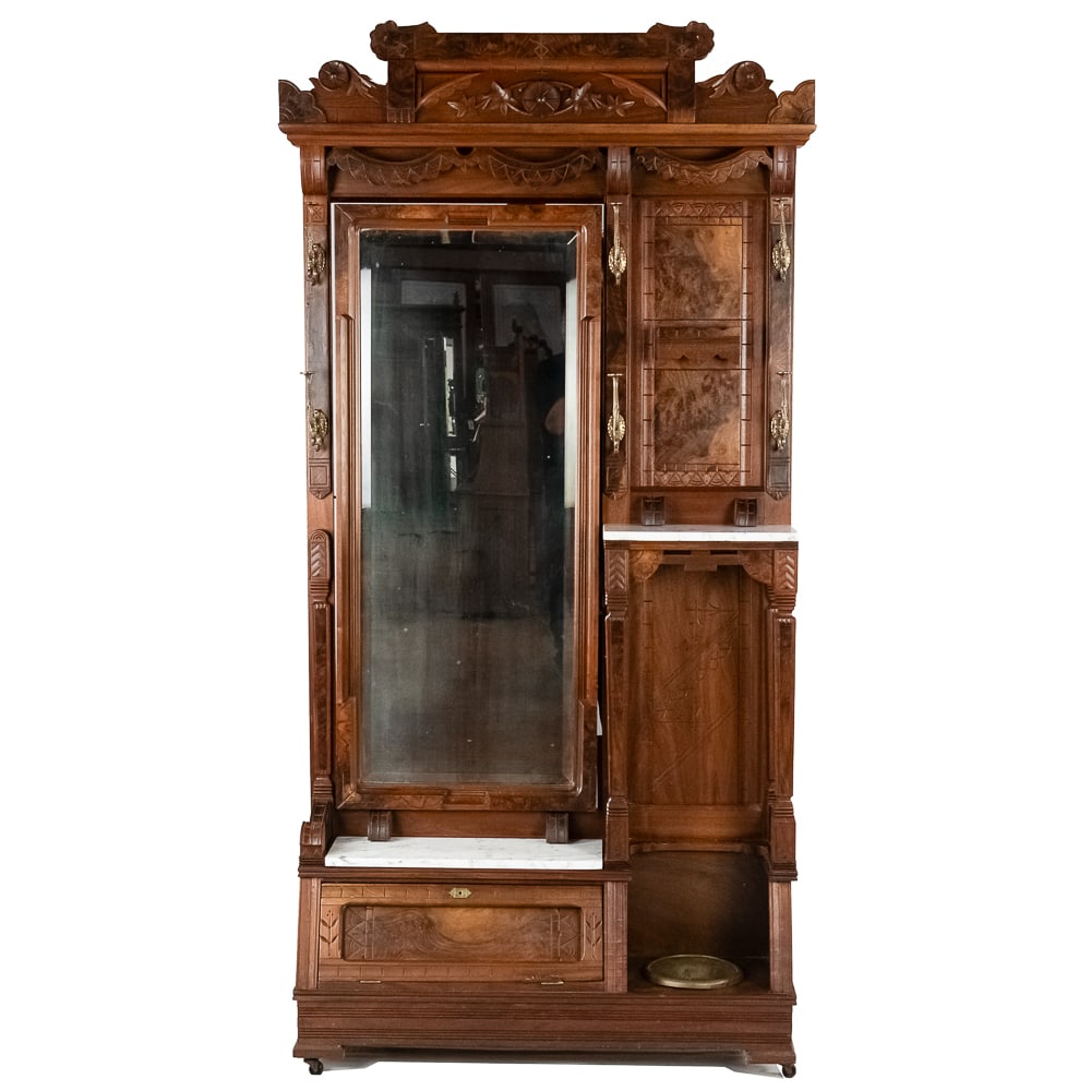 Eastlake Hall Mirror Coat Rack: Outstanding Eastlake hall mirror and coat rack from the 1880's Wood is walnut with inset burl panels. Has brass coat and hat hooks, umbrella storage with brass drip pan, a beveled glass tilting mirror