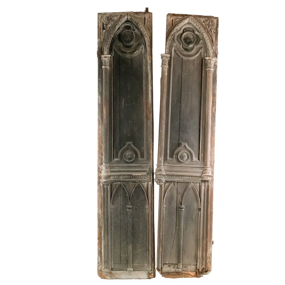 Pair Antique European Architectural Wood Doors: This is an exceptional pair of antique architectural wood panels, exhibiting highly detailed Gothic Revival or Neoclassical style elements. The design, featuring engaged columns with foliate capitals,