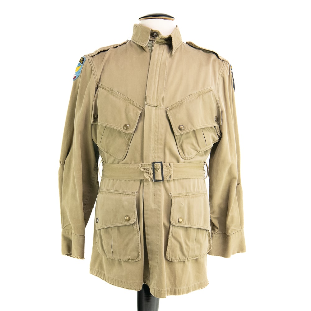 WWII US Army 101st & First Allied M42 Jump Jacket: M42 Jump Jacket. 101st Airborne (white tongue variant, on left shoulder) and First Allied Airborne Army (right shoulder) patched. 101st patch and above tab chain stitched in blue thread. First Allied