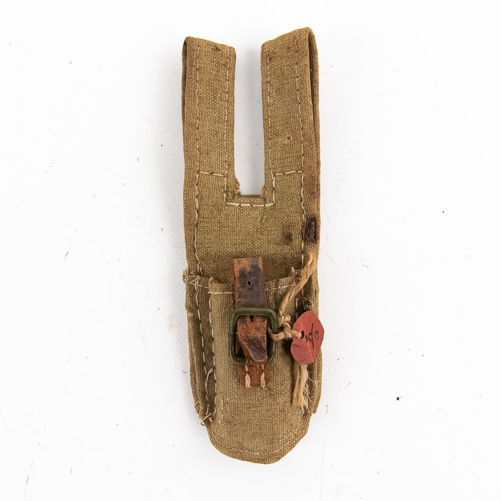 Nice Example of a Japanese Canvas Frog: 7 3/8" length, 2 piece construction with a tight weave. "OD" painted buckle with good leather strap. Heart shaped ID tag attached to buckle. 2 small "burn" holes in front and back, but still a very