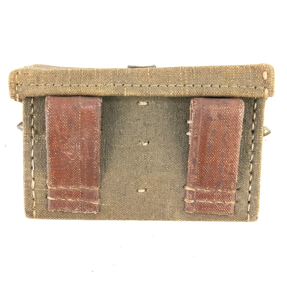 Japanese Arisaka Ammunition Pouch: A very nice original Japanese World War II ammunition pouch for Arisaka Rifles. The pouch is made of a hard shell with a textile cover and leather end caps. The two belt straps are made of rubberized