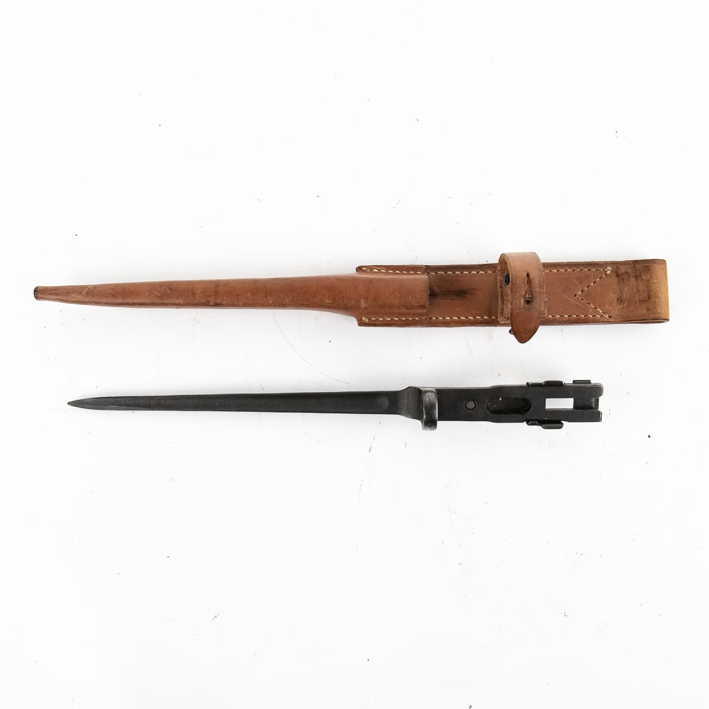 US 1941 Johnson Rifle Bayonet: Very rare Johnson rifle bayonet issued to U.S. Marines in WWII. Produced from a single billet of steel that was forged into shape. Triangular profile to blade with a 7" fuller on the blade. 11 3/4" in