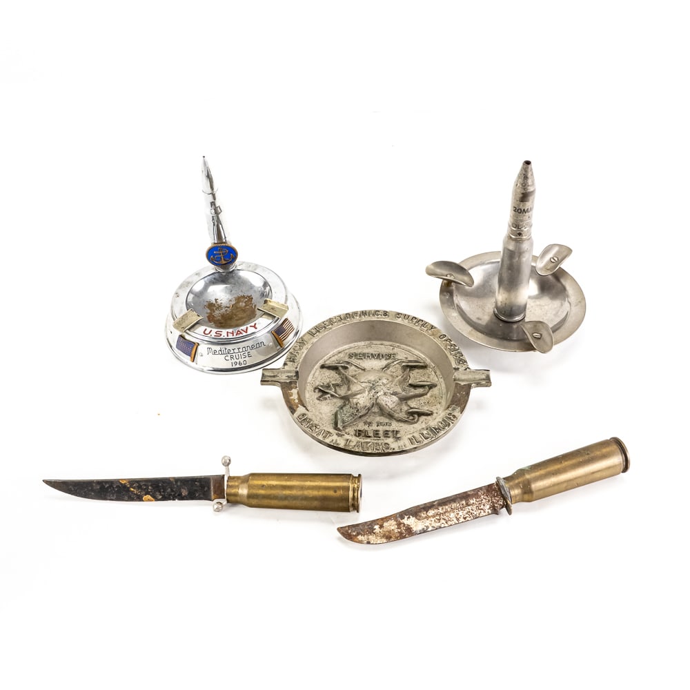 Trench Art/Souvenir Lot: 5 pieces of trench art and military souvenir items. Lot includes U.S. Navy Mediterranean Cruise 1960 Ashtray, 20mm bullet ashtray, 2 20mm rounds converted into letter opener knives(both blades very ru