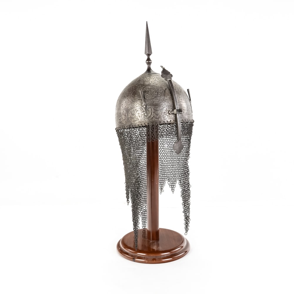 Indo-Persian Khula Khud Steel Helmet: This is a classic Indo-Persian Khula Khud helmet, likely dating to the 18th or 19th century, featuring the quintessential hemispherical bowl forged from steel. The surface is heavily adorned with
