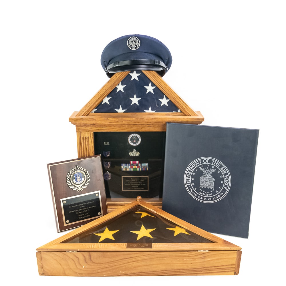 Burial Flag, USAF Display Case, Plaque, Cert, Cap: Grouping associated with Father and Son. Burial flag in wooden presentation case for Lester T. James (1917-1997). Dimensions: 24 in x 12 x 4 in. His son Senior Master Sergeant Charles L. James
