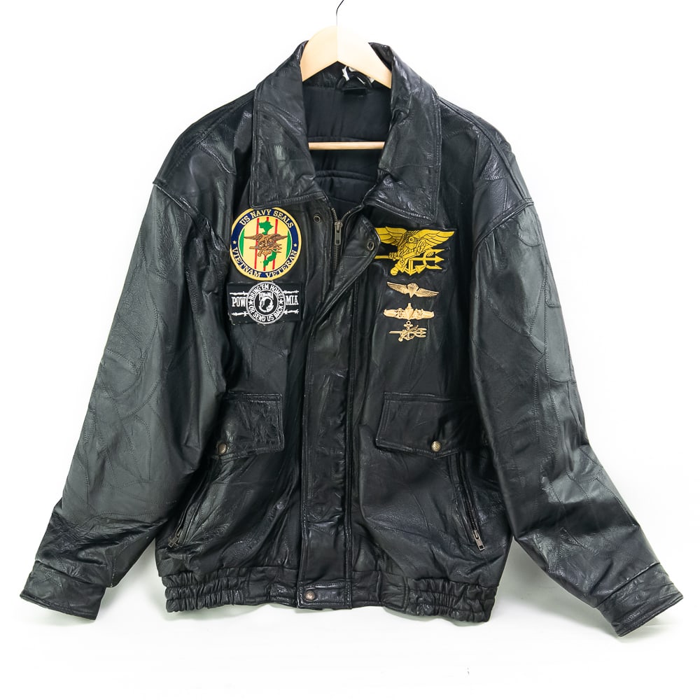 Leather Vietnam Veteran Jacket US Navy Seal Team: Leather Vietnam Veteran Jacket US Navy Seal TeamLeather jacket. Large size (44/46?). Two flap/zipper pockets on front. Pocket inside left breast. Zipper front w/snap enclosure. Patches: US Navy