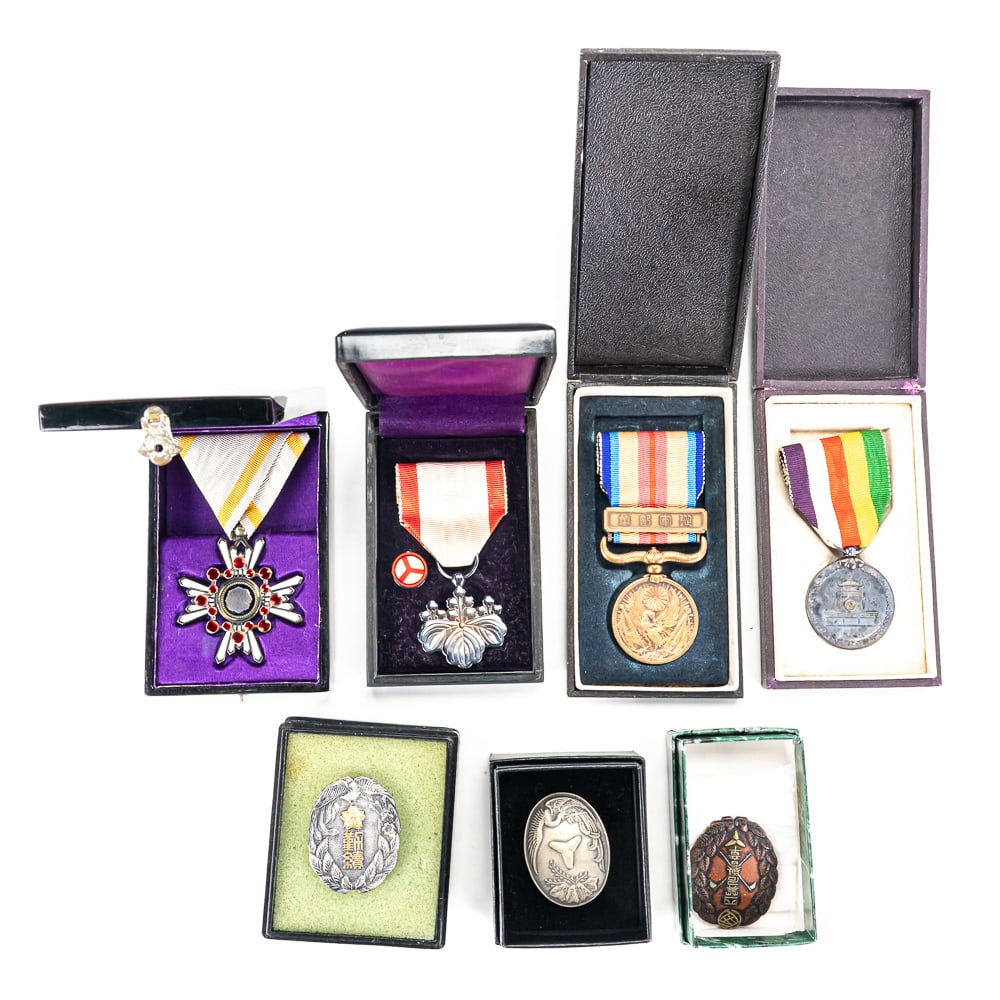 Imperial Japanese Cased Medals (7): This superb collection represents a comprehensive look into both Imperial Japanese military/civil service awards and commemorative decorations, meticulously curated and presented. At the pinnacle