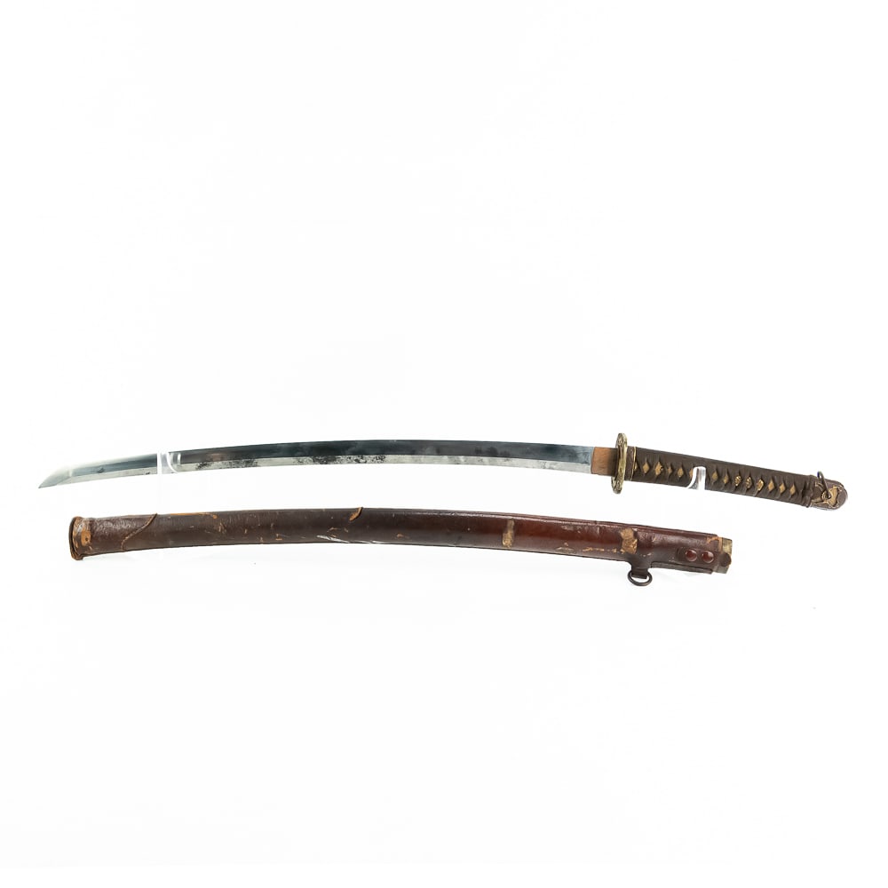 Japanese Army Officer Field Sword: BLADE: dated 1871, signed “Gasan Sada Kazu”. BLADE MARKINGS: Faint straight temper line. Blade shows pits and staining from handling. HABAKI: Copper with Rain Symbol. GUARD (Tsuba):
