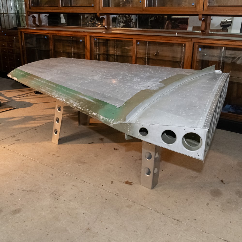 C47 Horizontal Stabilizer Wing Section Desk: Note: Pickup/Transport required. Contacts available post auction.WWII C-47 Dakota Stabilizer Wing DeskThis is a spectacular piece of "trench art" on a grand scale—a genuine horizontal