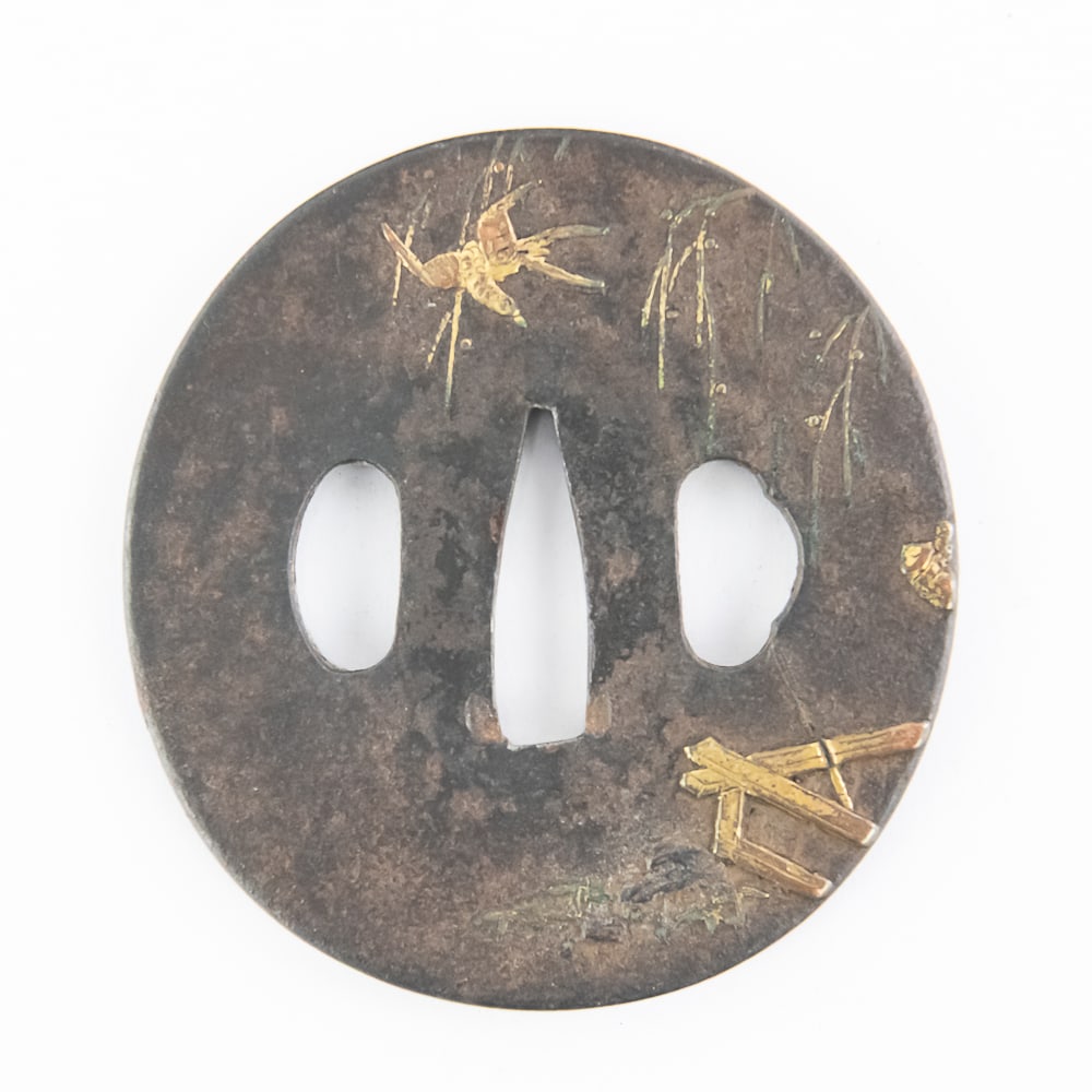 Antique Japanese Iron Tsuba with Gold Inlay: This is a beautiful example of a (tsuba) or sword guard, likely dating from the Edo period (1603-1868). Crafted from iron in the classic maru-gata (round) shape, it features fine gold-inlay decoration