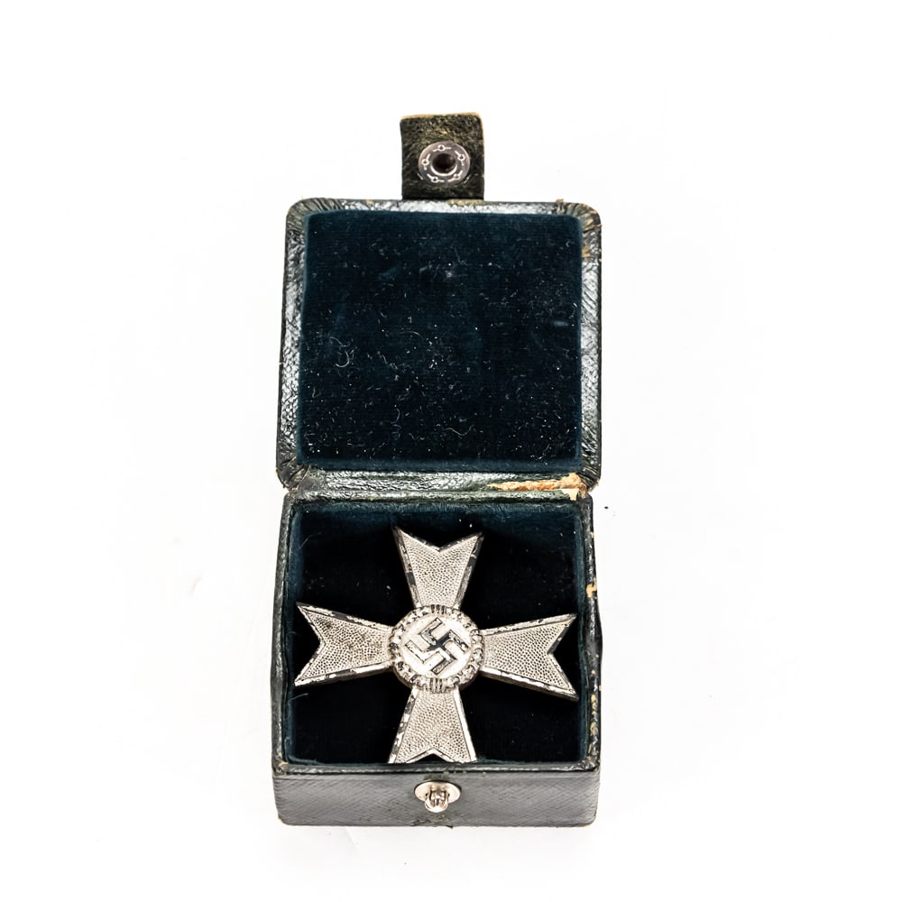 WWII German War Merit Cross 1st Class: This WWII-era German War Merit Cross 1st Class without Swords features the characteristic Maltese cross design with a pebbled finish on the arms and a central swastika within an oak leaf wreath.
