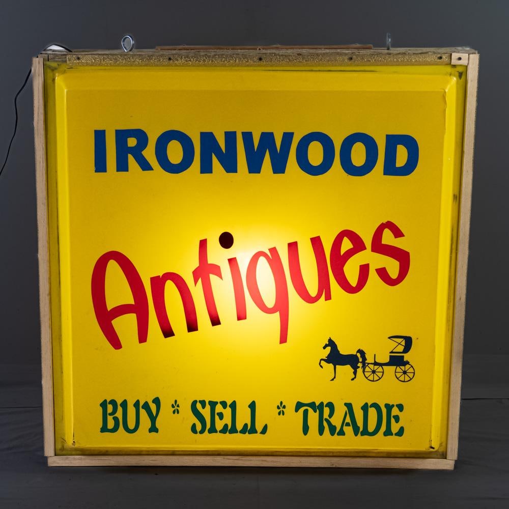 Ironwood Antiques Double Sided Advertising Sign: Ironwood Antiques Buy Sell Trade double sided acrylic illuminated hanging advertising sign with wooden frameing. Hangs 42" t x 12"x d x 42"w and in good overall condition with age and wear related cos