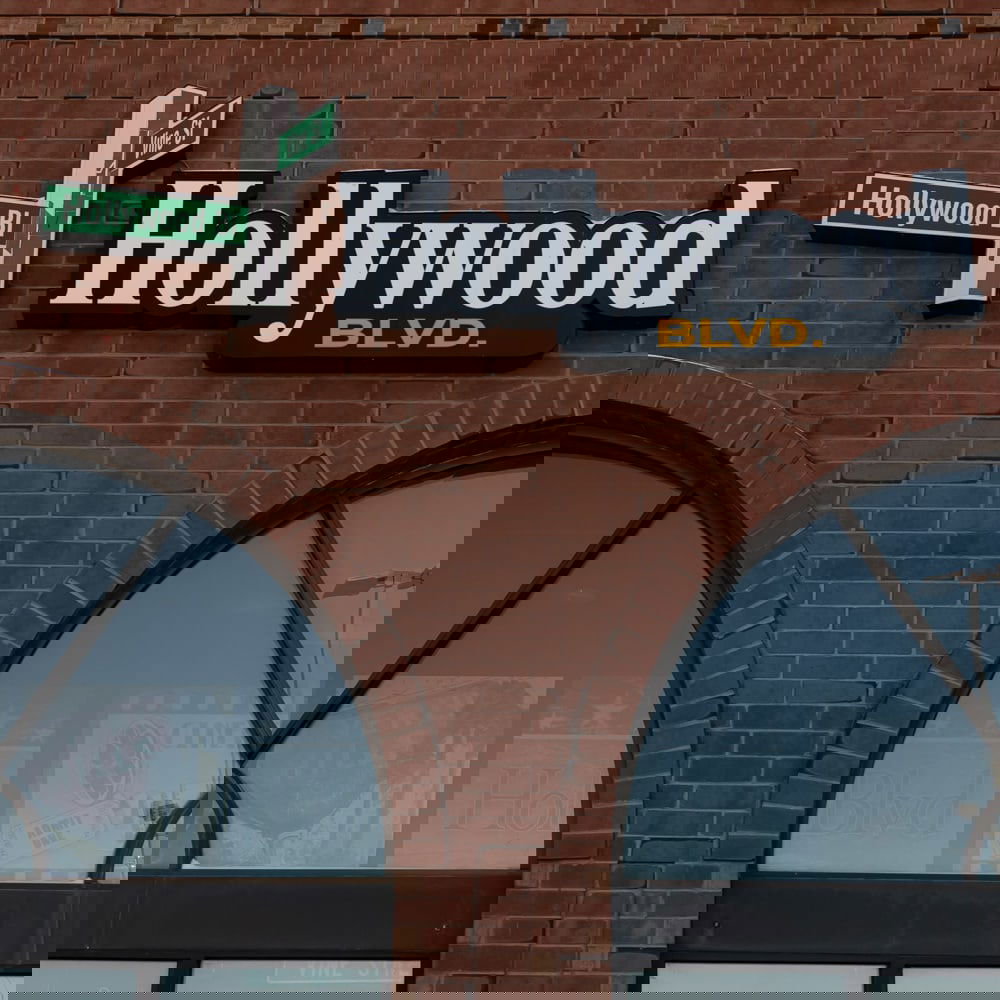 Outdoor Hollywood Blvd. Sign W/Street Signs: Pair of exterior building signage for "Hollywood Blvd," from the iconic cinema and eatery in Woodridge, Illinois. The set includes the large-scale "Hollywood BLVD." channel letter sign with its