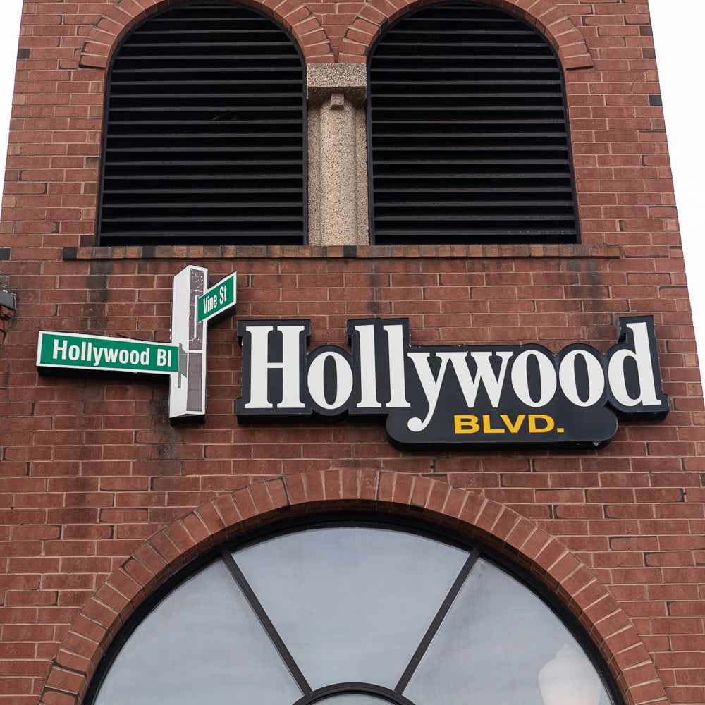 Hollywood Sign on Tower: Pair of exterior building signage for "Hollywood Blvd," from the iconic cinema and eatery in Woodridge, Illinois. The set includes the large-scale "Hollywood BLVD." channel letter sign with its