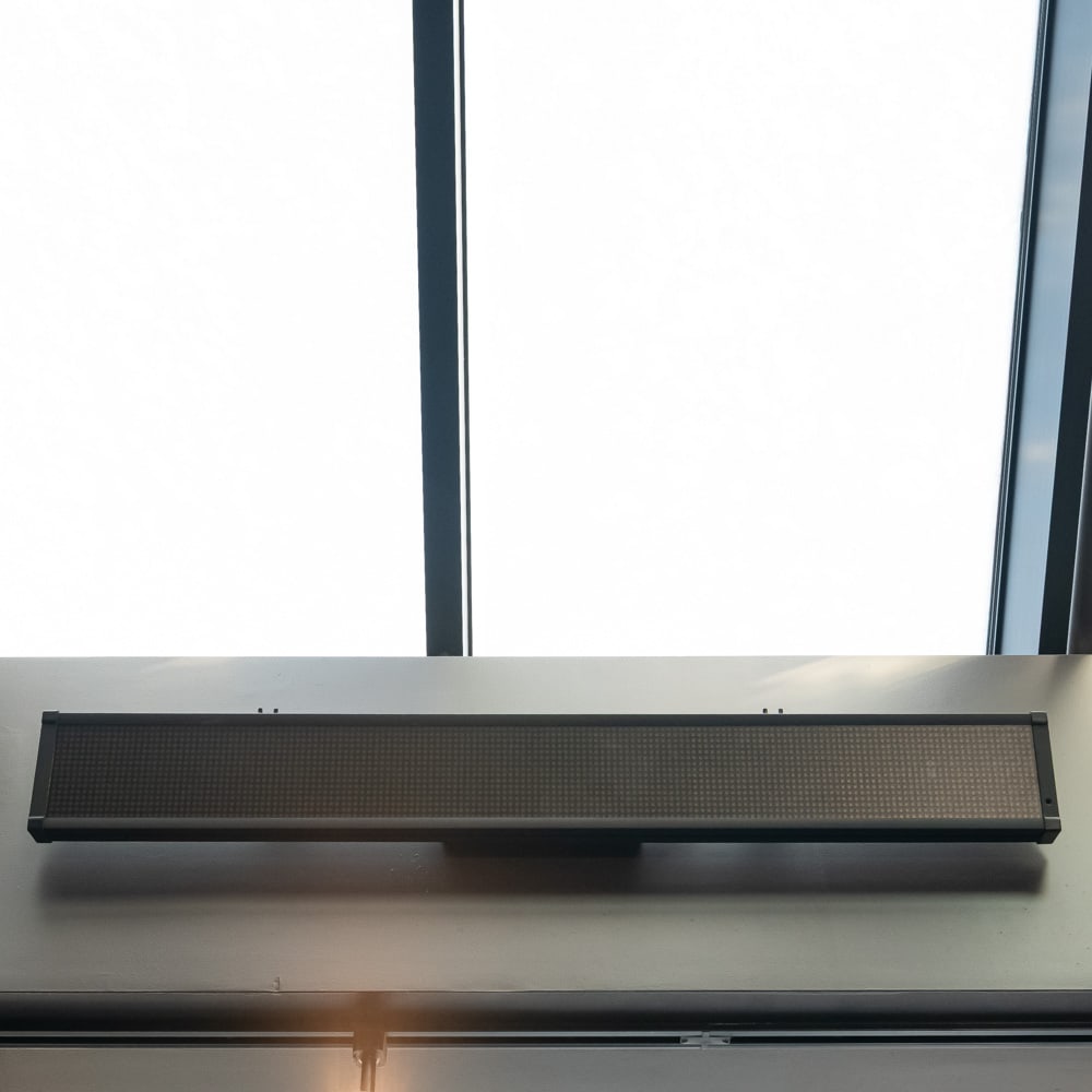 LED Light Bar - Pub Table Area: This sleek, modern electronic scrolling message sign features a high-density LED matrix encased in a durable black finished metal housing. Ideal for commercial storefronts or industrial information di