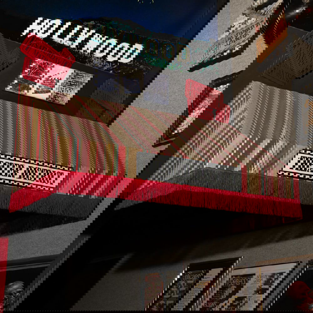 Theater District Awning: Cloth awning with fringe with attached sign for Theater District. Located in the lobby. In good condition. Measures 21" deep x 57" wide x 29" tall. Please use photos to judge condition and bid