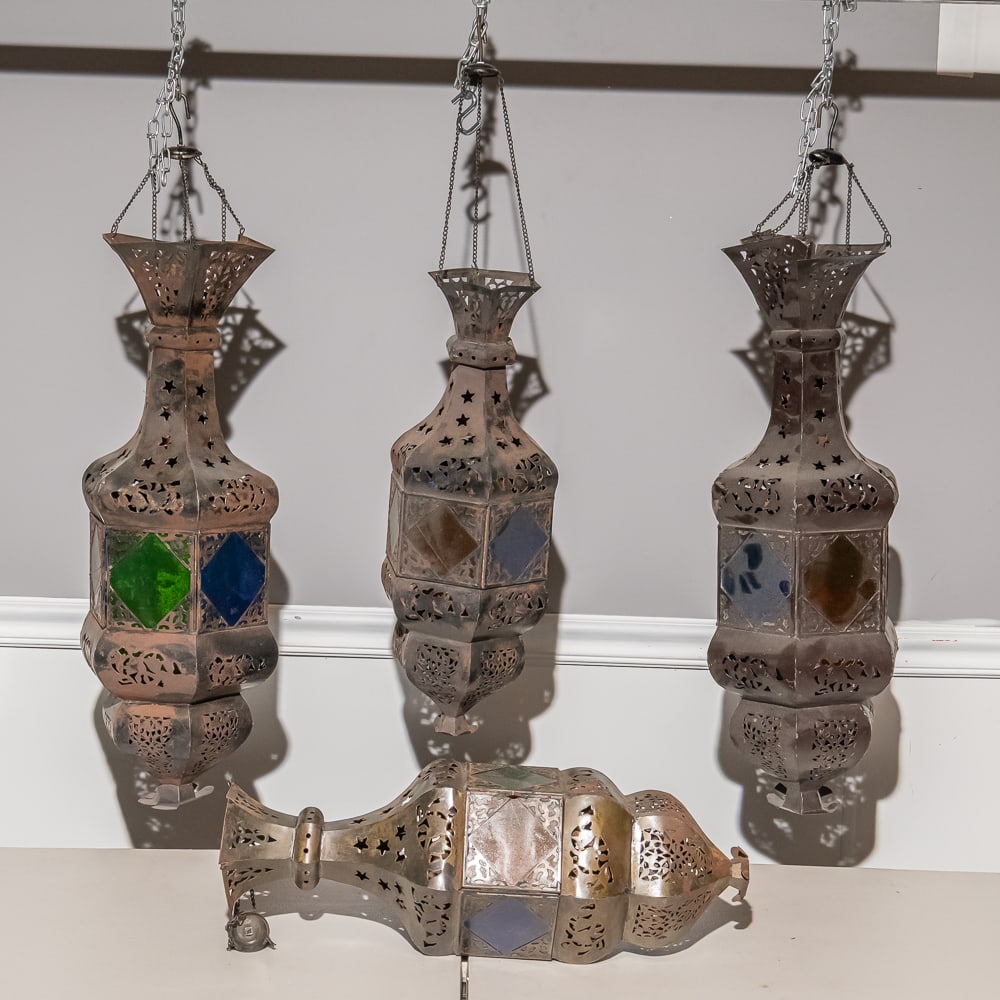 4 Moroccan Style Pierced Metal Lanterns w/2 Rods: This striking set of four Moroccan-inspired pierced lanterns showcases the intricate "Mousharabi" style of metalwork, likely dating to the mid-20th century. Each vessel features a series of hand-punch
