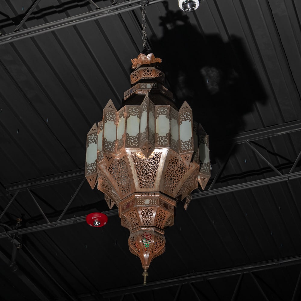 Large Moorish Style hanging Light Fixture: Large Moorish style hanging light fixture made of pierced metal with frosted glass inserts. In good condition. Measures approx 48" tall x 24" diameter. Please use photos to judge condition and bid