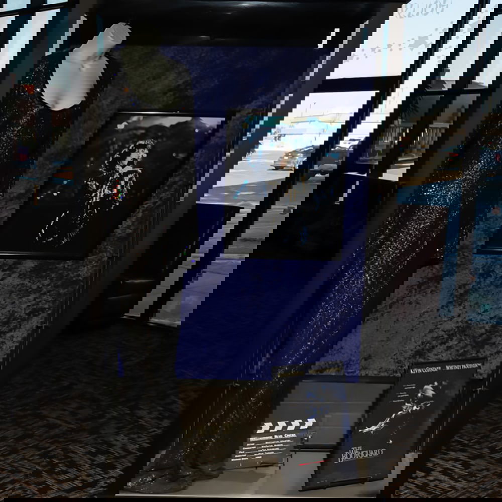 Whitney Houston Dress From "The Bodyguard" Movie: Whitney Houston screen worn dress from the 1992 Warner Brothers movie, The Bodyguard. Includes, dress, display mannequin, photo, mini poster, and clap board. Display case sold separate as next lot.