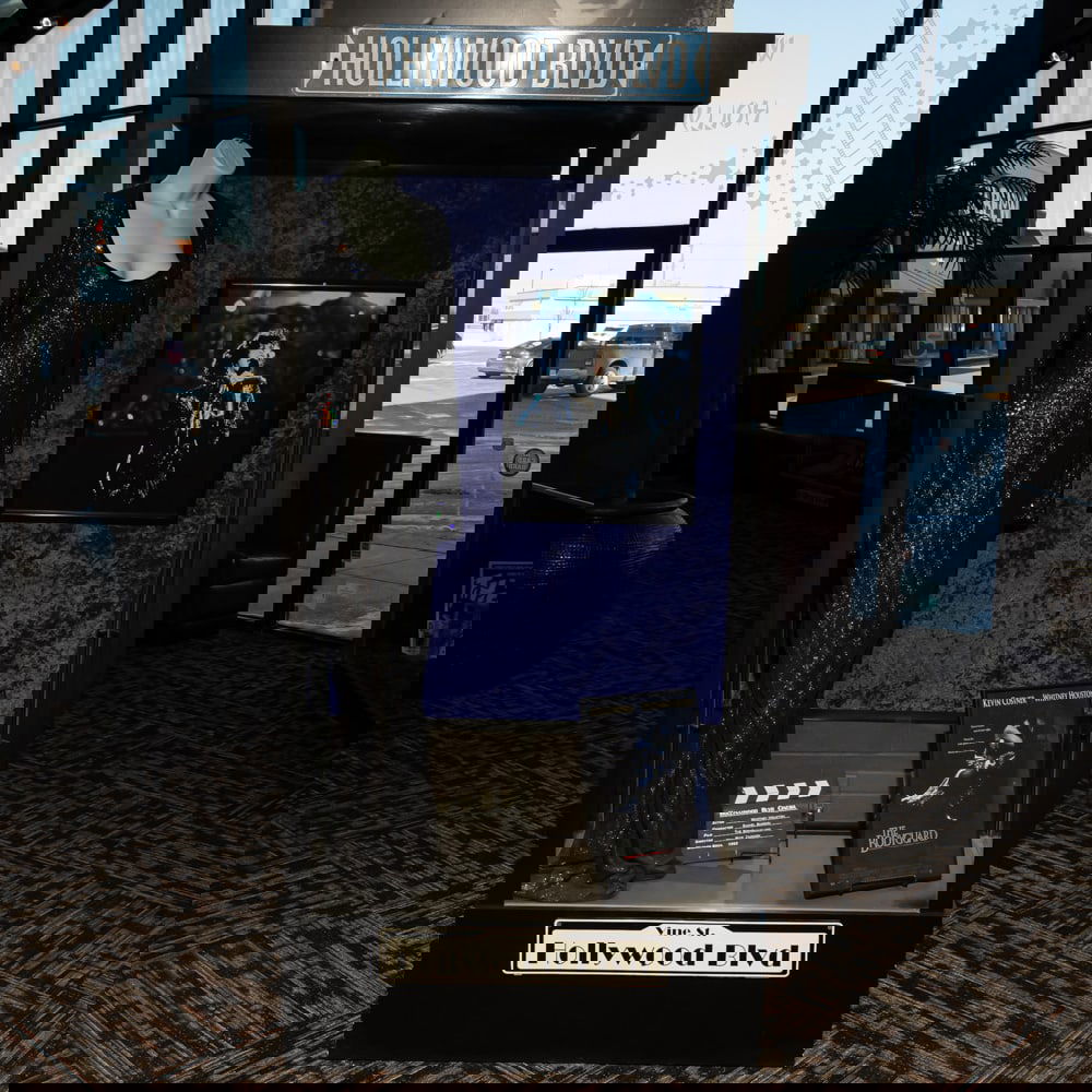 Glass Display Showcase: Side entrance lighted glass display case in good condition. Measures 82" tall, 39" wide, 17" deep. Please use photos to judge condition and bid accordingly. Please note: Buyer is responsible for remov