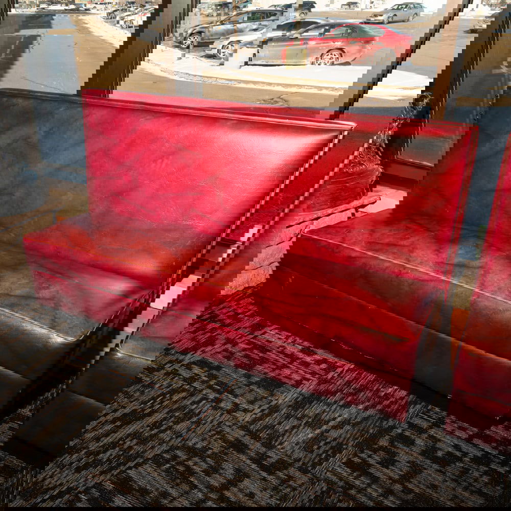 Vintage Restaurant Booth Bench: Classic mid-century style commercial restaurant booth, featuring a robust high-back design upholstered in a marbled or "cracked ice" patterned burgundy leatherette. This style was a staple of