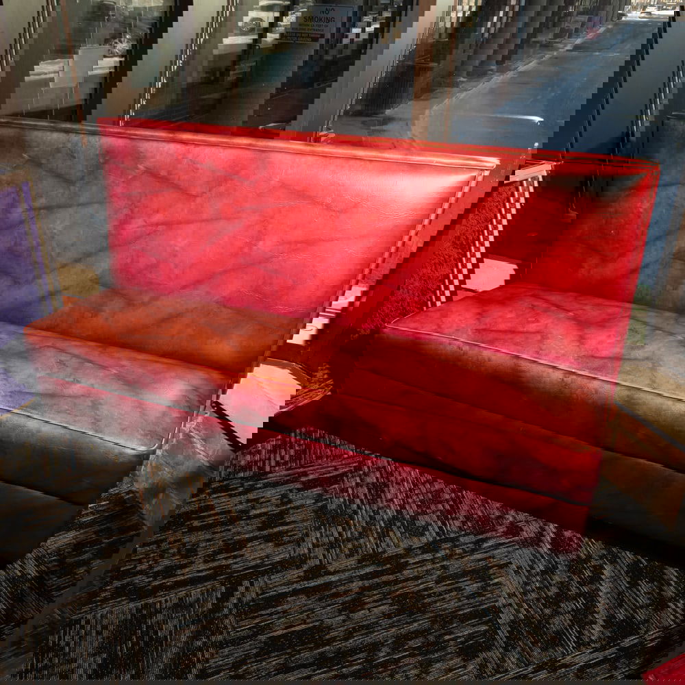 Vintage Restaurant Booth Bench: Classic mid-century style commercial restaurant booth, featuring a robust high-back design upholstered in a marbled or "cracked ice" patterned burgundy leatherette. This style was a staple of