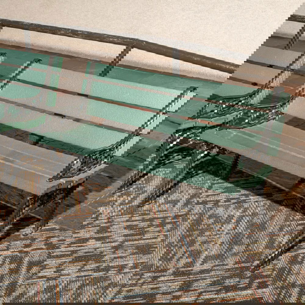 Cast Iron & Green Poly Slat Garden Bench: This classic park-style garden bench features robust, decorative cast iron ends with elegant scrollwork and "Medallion" style detailing, reminiscent of early 20th-century municipal furniture. The