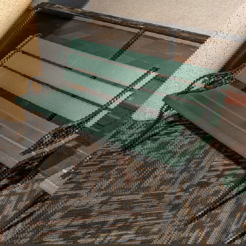 Cast Iron & Green Poly Slat Garden Bench: This classic park-style garden bench features robust, decorative cast iron ends with elegant scrollwork and "Medallion" style detailing, reminiscent of early 20th-century municipal furniture. The seat