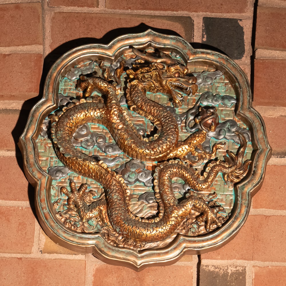 Antique Gilded Wood Dragon Cloud Plaque: This masterfully executed high-relief carving features a dynamic, five-clawed Imperial dragon winding through a dense field of stylized "ruyi" clouds. While the deep verdigris-style patina in the rece
