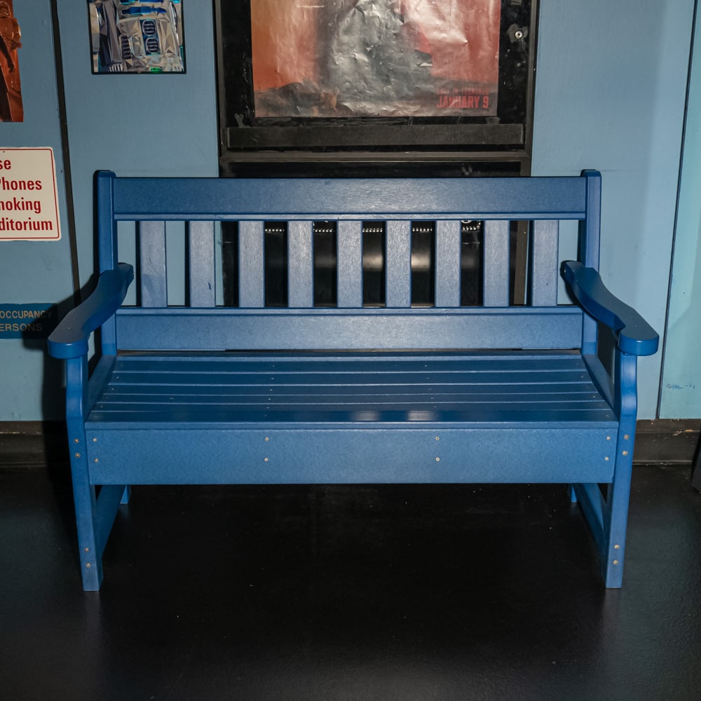 Blue Wood Bench Theater #2: Wood bench with slat back painted blue outside theater # 2. In good condition. Measures 52.5" wide X 34.25" tall X 25" deep. Please use photos to judge condition and bid accordingly. Please note: Buye