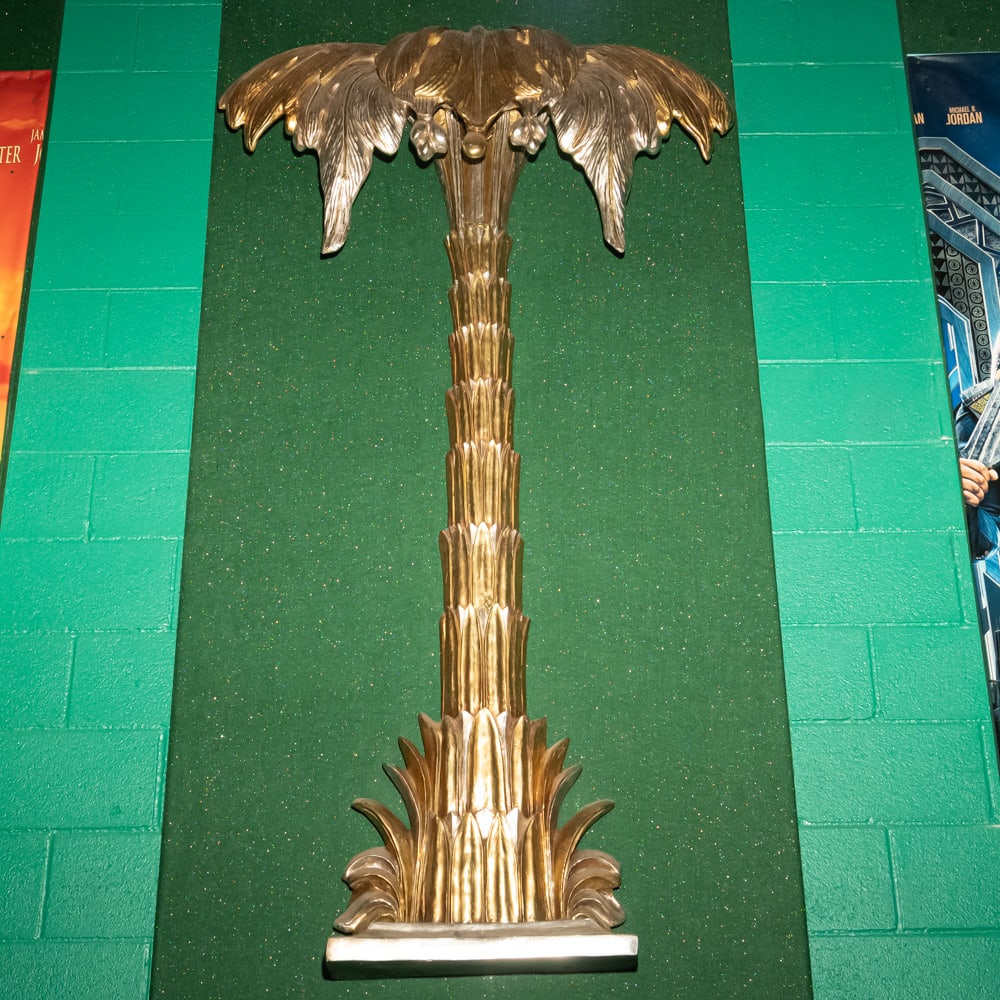 Gilded Palm Tree Wall Sconce Th. 3: This striking Hollywood Regency style palm tree wall relief features a brilliant gold-leaf or gilded finish over what appears to be a cast composite or heavy resin material. Evoking the mid-century gl