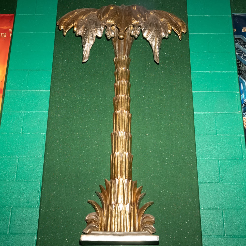 Gilded Palm Tree Wall Sconce Th. 3: This striking Hollywood Regency style palm tree wall relief features a brilliant gold-leaf or gilded finish over what appears to be a cast composite or heavy resin material. Evoking the mid-century gl