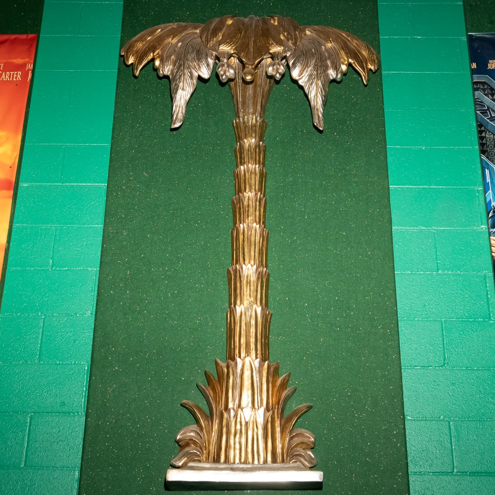 Gilded Palm Tree Wall Sconce Th. 3: This striking Hollywood Regency style palm tree wall relief features a brilliant gold-leaf or gilded finish over what appears to be a cast composite or heavy resin material. Evoking the mid-century gl