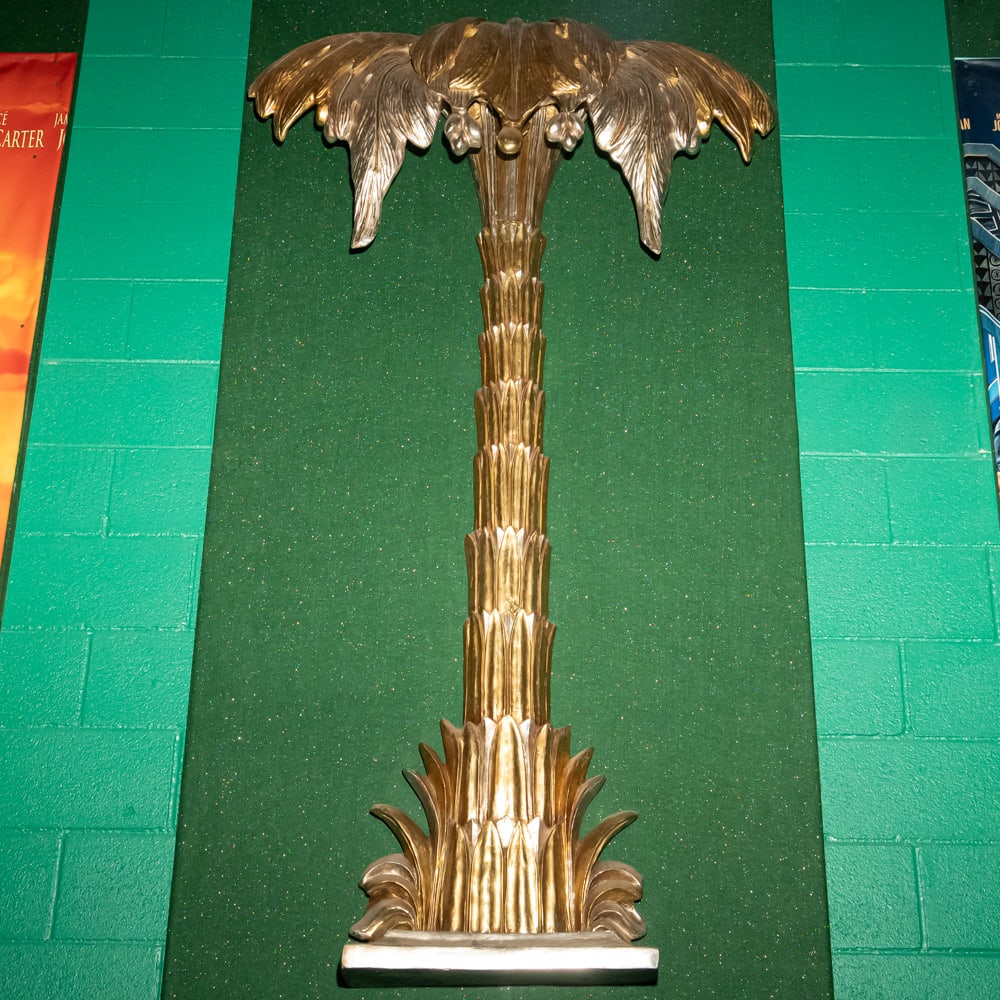 Gilded Palm Tree Wall Sconce Th. 3: This striking Hollywood Regency style palm tree wall relief features a brilliant gold-leaf or gilded finish over what appears to be a cast composite or heavy resin material. Evoking the mid-century gl