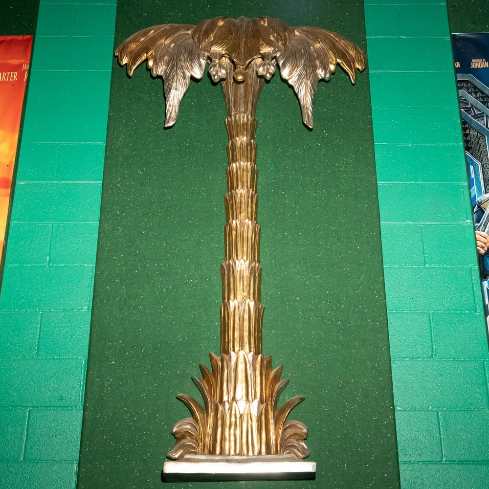 Gilded Palm Tree Wall Sconce Th. 3: This striking Hollywood Regency style palm tree wall relief features a brilliant gold-leaf or gilded finish over what appears to be a cast composite or heavy resin material. Evoking the mid-century gl