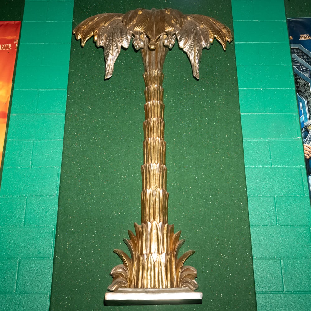 Gilded Palm Tree Wall Sconce Th. 3: This striking Hollywood Regency style palm tree wall relief features a brilliant gold-leaf or gilded finish over what appears to be a cast composite or heavy resin material. Evoking the mid-century gl