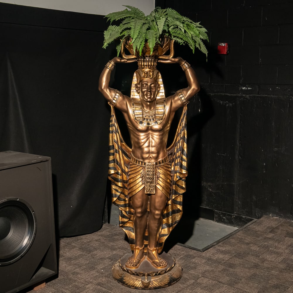 Egyptian Man Statue/Planter: This striking life-sized floor planter captures the "Egyptomania" revival style with its bold Art Deco lines and dramatic gold and black polychrome finish. Depicting a pharaoh in a ceremonial headdres