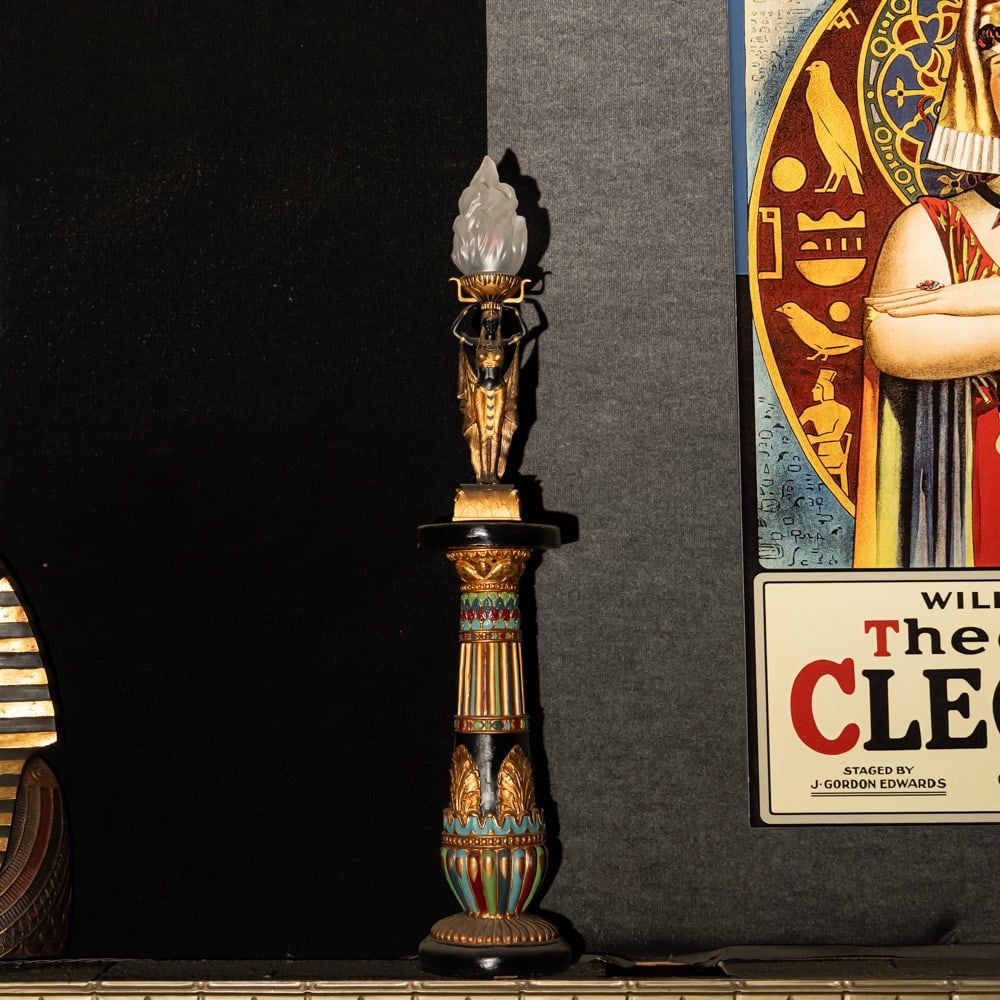 Egyptian Torch Lamp: A Golden Age Redux: Egyptian Torch Lamp: A Golden Age Redux. This striking figural lamp features a meticulously detailed Pharaoh sculpture in hand-painted resin, elevating an illuminated glass flame shade to create a dra
