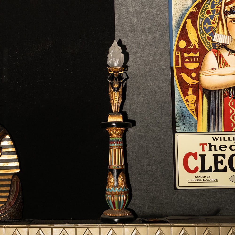 Egyptian Torch Lamp: A Golden Age Redux: Egyptian Torch Lamp: A Golden Age Redux. This striking figural lamp features a meticulously detailed Pharaoh sculpture in hand-painted resin, elevating an illuminated glass flame shade to create a dra