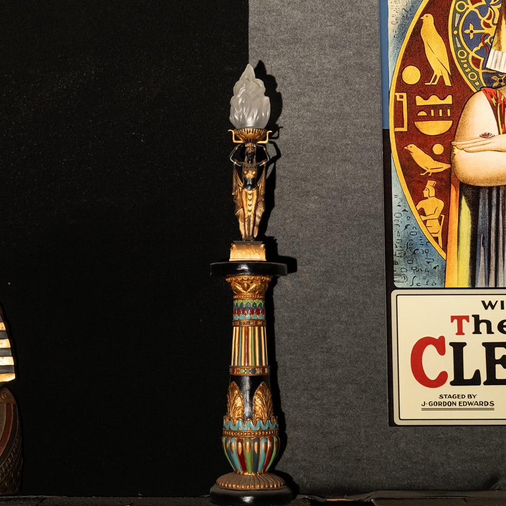 Egyptian Torch Lamp: A Golden Age Redux: Egyptian Torch Lamp: A Golden Age Redux. This striking figural lamp features a meticulously detailed Pharaoh sculpture in hand-painted resin, elevating an illuminated glass flame shade to create a dra