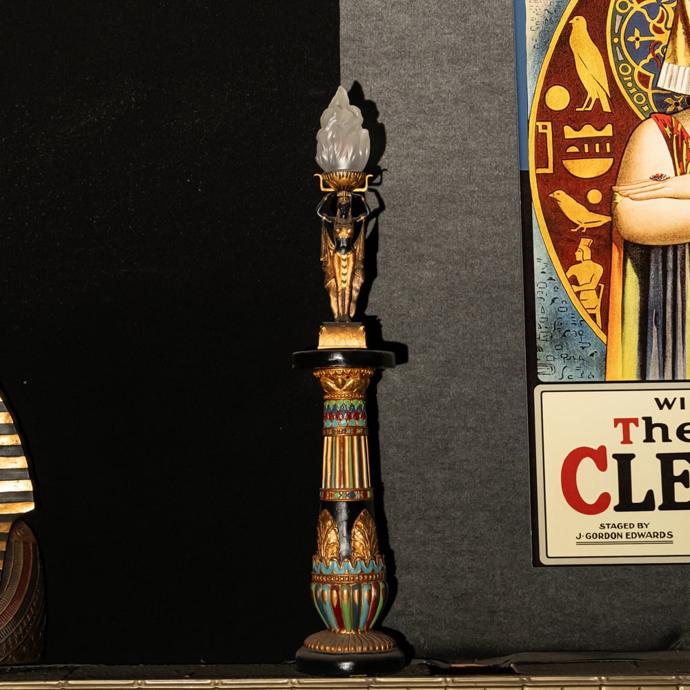 Egyptian Torch Lamp: A Golden Age Redux: Egyptian Torch Lamp: A Golden Age Redux. This striking figural lamp features a meticulously detailed Pharaoh sculpture in hand-painted resin, elevating an illuminated glass flame shade to create a dra