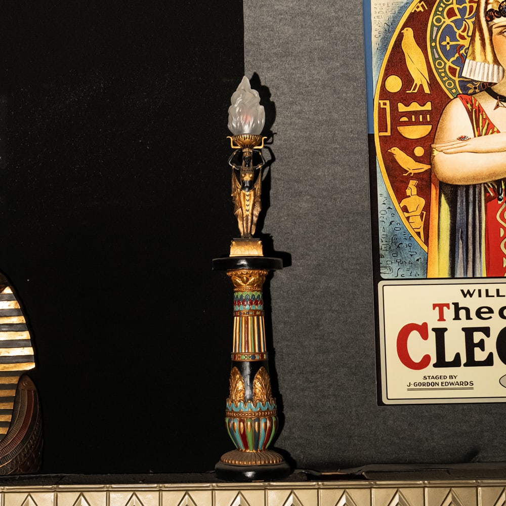 Egyptian Torch Lamp: A Golden Age Redux: Egyptian Torch Lamp: A Golden Age Redux. This striking figural lamp features a meticulously detailed Pharaoh sculpture in hand-painted resin, elevating an illuminated glass flame shade to create a dra