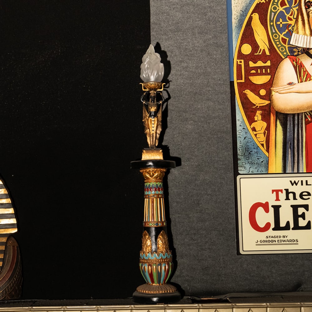 Egyptian Torch Lamp: A Golden Age Redux: Egyptian Torch Lamp: A Golden Age Redux. This striking figural lamp features a meticulously detailed Pharaoh sculpture in hand-painted resin, elevating an illuminated glass flame shade to create a dra