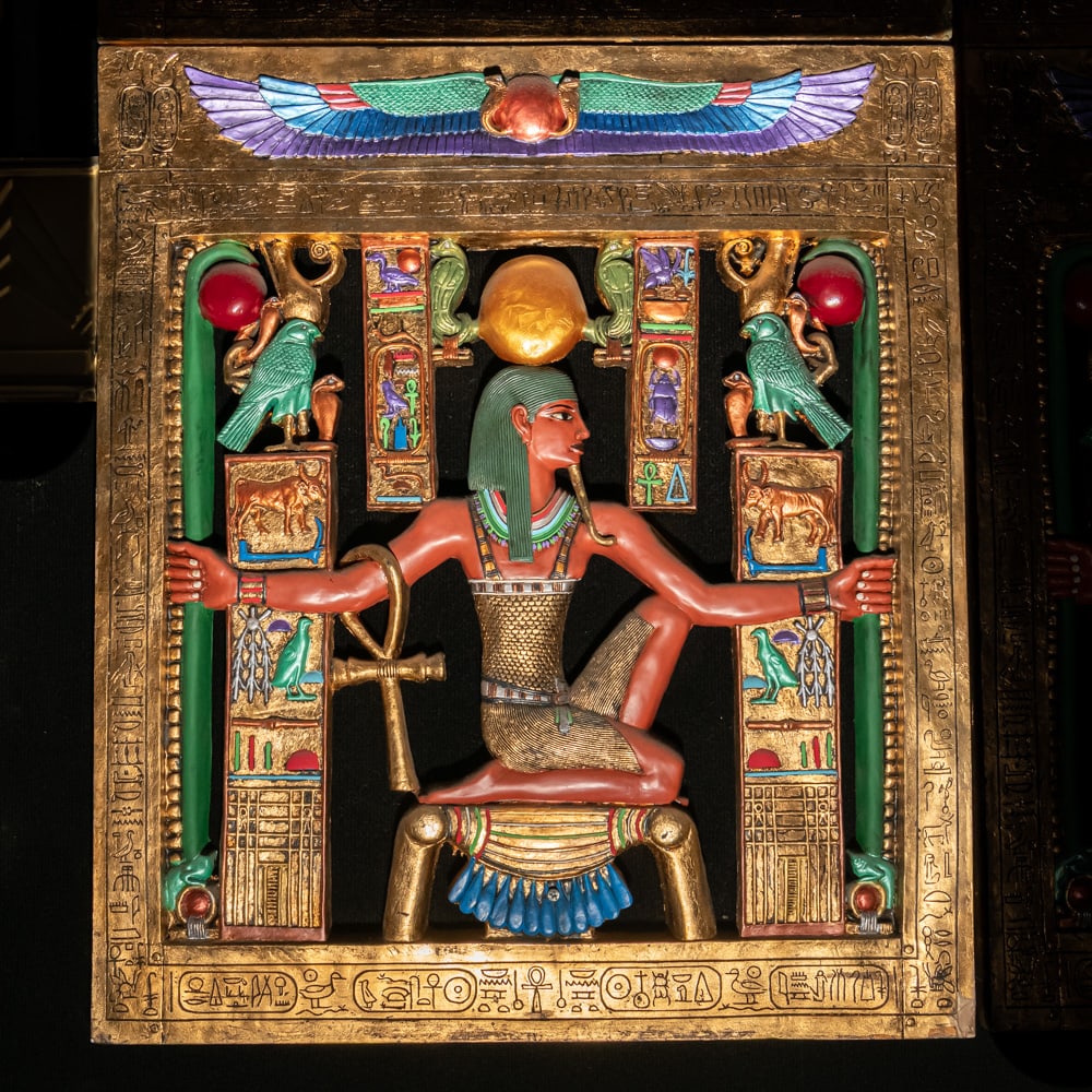 Egyptian Revival Heh Eternity Plaque: This stunning Egyptian Revival decorative plaque depicts the god Heh, the personification of infinity and eternity, rendered in a style reminiscent of the treasures found in Tutankhamun's tomb. The fi