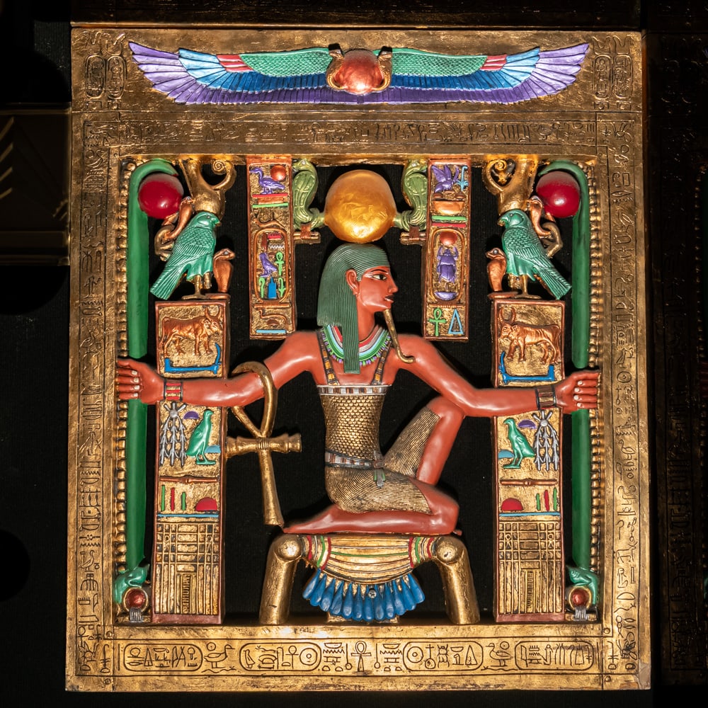 Egyptian Revival Heh Eternity Plaque: This stunning Egyptian Revival decorative plaque depicts the god Heh, the personification of infinity and eternity, rendered in a style reminiscent of the treasures found in Tutankhamun's tomb. The