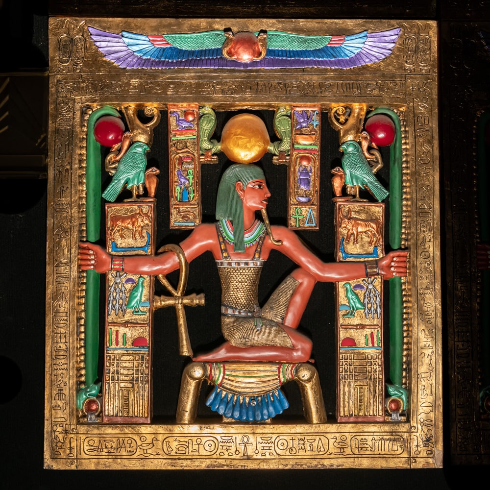 Egyptian Revival Heh Eternity Plaque: This stunning Egyptian Revival decorative plaque depicts the god Heh, the personification of infinity and eternity, rendered in a style reminiscent of the treasures found in Tutankhamun's tomb. The
