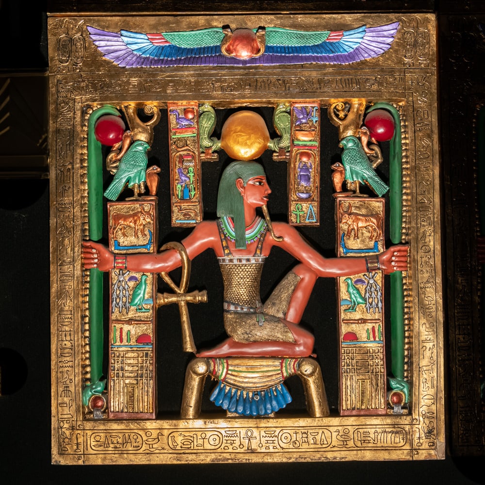 Egyptian Revival Heh Eternity Plaque: This stunning Egyptian Revival decorative plaque depicts the god Heh, the personification of infinity and eternity, rendered in a style reminiscent of the treasures found in Tutankhamun's tomb. The fi