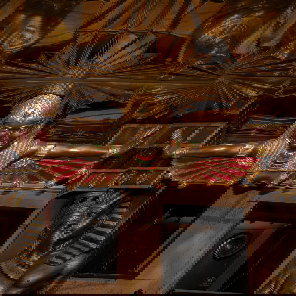 Egyptian Revival Winged Isis Coat Rack: A grand Egyptian Revival wall relief doubles as a functional garment or hat rack, featuring the goddess Isis with her protective wings outstretched in a classic protector's stance. The piece is finish