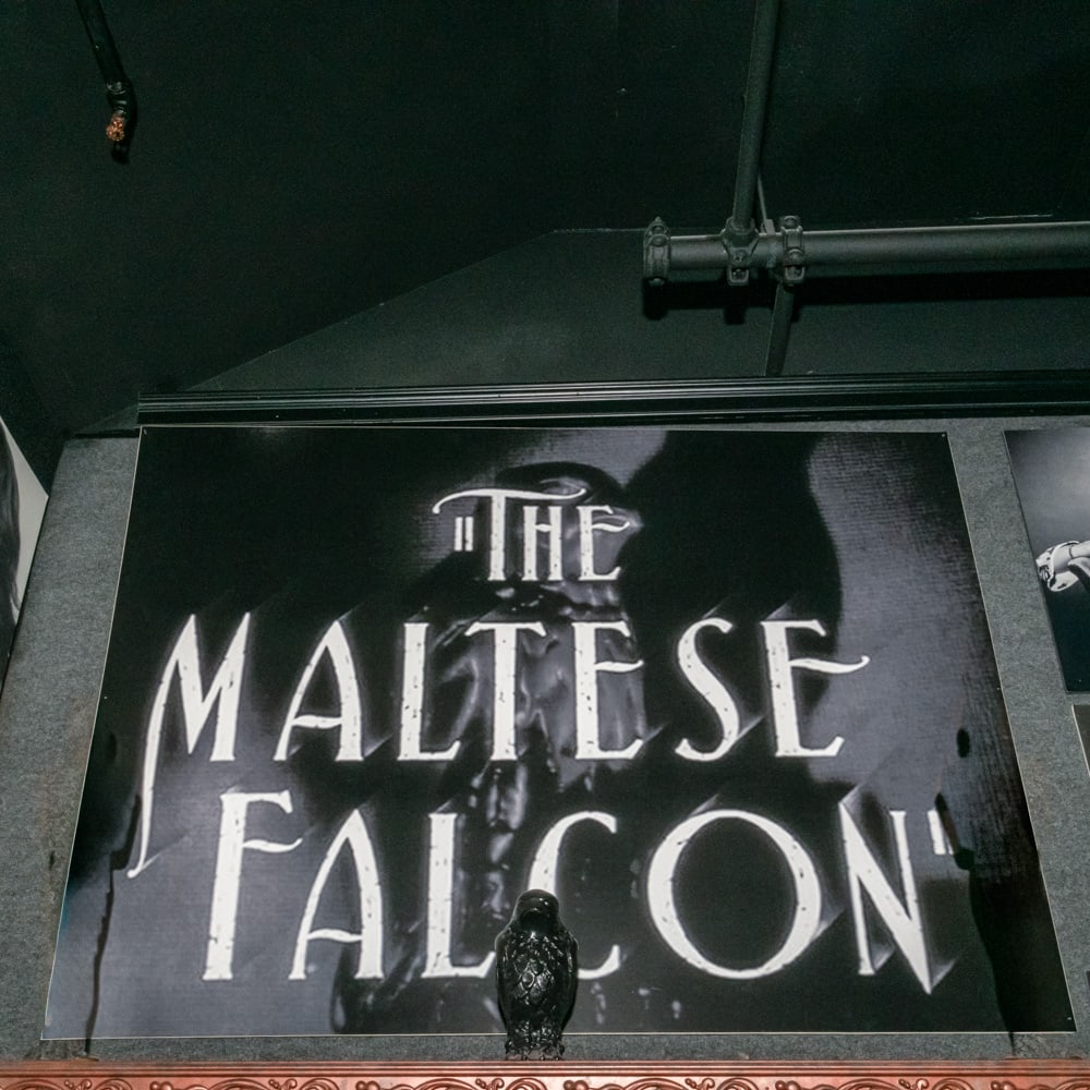 Maltese Falcon Sign, Falcon, and Photo Prints: Four items pertaining to the 1941 movie, The Maltese Falcon starring Humphrey Bogart include a B&W print of the movie title mounted on foam board measures 60" X 48", a framed B&W photo print of