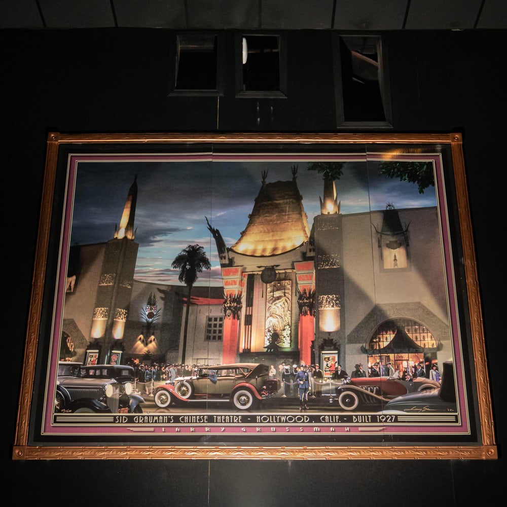 Larry Grossman Grauman's Chinese Theater Mural: Large mural print of the Sid Grauman's Chinese Theater in Hollywood California 1927 by artist Larry Grossman. Mounted on foam core board in 3 panels with a decorative metal frame. Measures 8' tall, 10